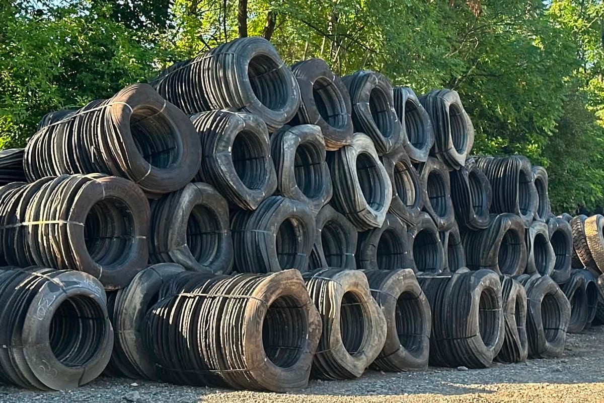 Banded bundles of cut truck tire sidewalls stacked several rows high at the Hollidaysburg yard
